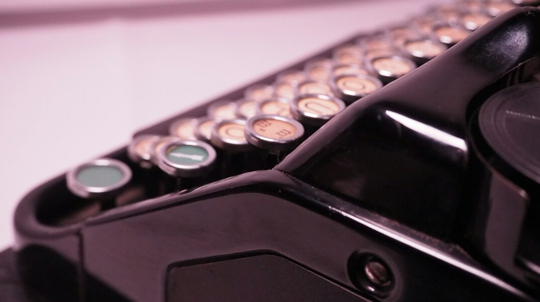 Close-up photo of an old black typewriter with paper loaded