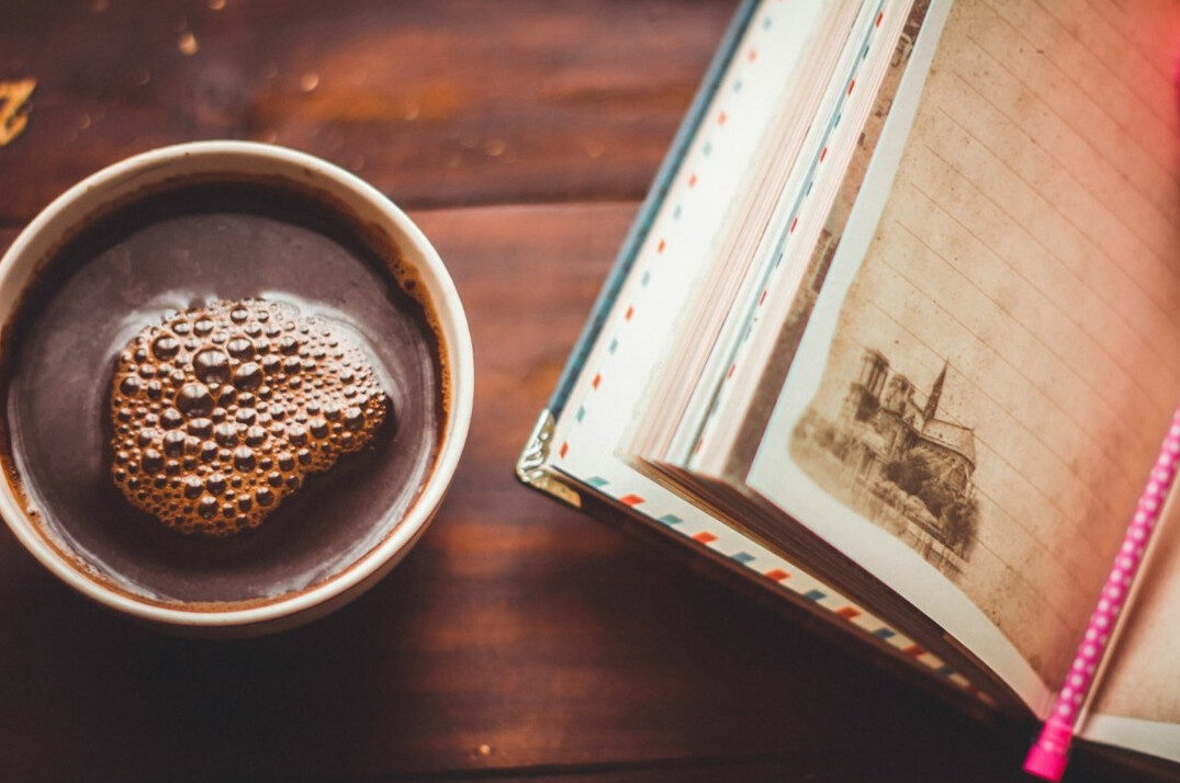 open mystery book with coffee