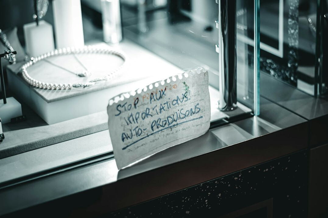 Open notebook covered in handwritten notes next to a magnifying glass