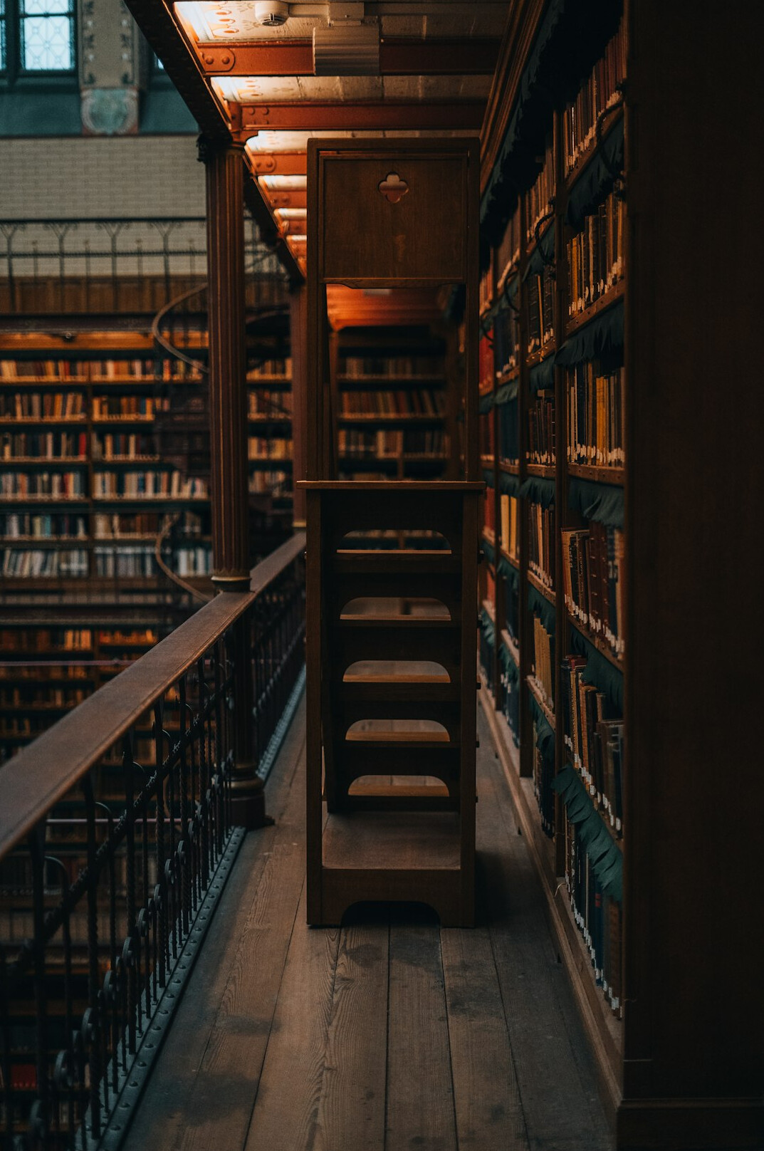 Interior of an old library with tall wooden bookshelves